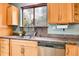 Bright kitchen featuring stainless steel appliances, granite countertops, and natural wood cabinetry at 2654 Sinton Rd, Evergreen, CO 80439