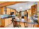Beautiful kitchen featuring wood cabinets, a breakfast bar with seating, and stainless steel appliances, filled with natural light at 2654 Sinton Rd, Evergreen, CO 80439