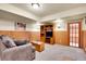 Cozy living room with wood-paneled walls, built-in shelving and a comfortable grey sofa at 2654 Sinton Rd, Evergreen, CO 80439