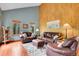 Living room featuring wood floors, vaulted ceilings, and comfortable leather furnishings at 2654 Sinton Rd, Evergreen, CO 80439