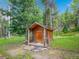 Exterior view of rustic shed surrounded by beautiful greenery and tall trees at 2654 Sinton Rd, Evergreen, CO 80439