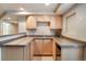 Basement wet bar with granite countertops and wood cabinets at 12444 Knox Ct, Broomfield, CO 80020