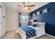 Cozy bedroom with a full-size bed and blue accent wall at 12444 Knox Ct, Broomfield, CO 80020