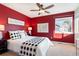 Charming bedroom with a queen-size bed and red walls at 12444 Knox Ct, Broomfield, CO 80020