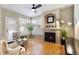 Cozy Gathering room with fireplace, hardwood floors, and large windows at 12444 Knox Ct, Broomfield, CO 80020