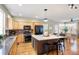 Modern kitchen with large island, stainless steel appliances, and hardwood floors at 12444 Knox Ct, Broomfield, CO 80020