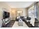 Spacious living room featuring a sectional sofa and large TV at 12444 Knox Ct, Broomfield, CO 80020