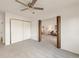Bedroom view through open doors to living room, featuring a ceiling fan and closet at 13606 E Bates Ave # 309, Aurora, CO 80014
