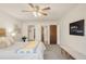 Bright bedroom featuring a comfortable bed, ceiling fan and closet access at 13606 E Bates Ave # 309, Aurora, CO 80014
