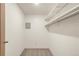 Walk-in closet with neutral carpet and built-in white shelving for storage and organization at 13606 E Bates Ave # 309, Aurora, CO 80014