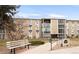 A tan condo building with 3 stories and well-maintained landscaping at 13606 E Bates Ave # 309, Aurora, CO 80014