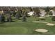 Scenic view of a golf course showcasing mature trees and sand traps adjacent to neighborhood buildings at 13606 E Bates Ave # 309, Aurora, CO 80014