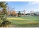 Beautiful golf course featuring a vibrant green putting green, water feature and community buildings at 13606 E Bates Ave # 309, Aurora, CO 80014