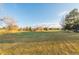 Scenic golf course view with expansive green lawns surrounded by mature trees under a clear blue sky at 13606 E Bates Ave # 309, Aurora, CO 80014