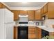 A kitchen with ample cabinet space, white appliances, and white countertops at 13606 E Bates Ave # 309, Aurora, CO 80014