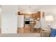 The kitchen and dining area feature wood cabinets and stainless steel appliances at 13606 E Bates Ave # 309, Aurora, CO 80014