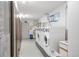 Functional laundry room with multiple washing machines and door leading outside at 13606 E Bates Ave # 309, Aurora, CO 80014