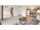 Open-concept living area connecting to the kitchen with hardwood and carpeted floors at 13606 E Bates Ave # 309, Aurora, CO 80014