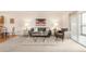 Open living space featuring neutral paint, plush carpet, and bright lighting at 13606 E Bates Ave # 309, Aurora, CO 80014