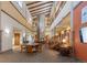 Impressive lobby with high ceilings, stone fireplace, staircase, and sitting area at 13606 E Bates Ave # 309, Aurora, CO 80014