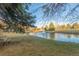 Peaceful pond featuring a fountain surrounded by lush greenery and a bench for relaxation at 13606 E Bates Ave # 309, Aurora, CO 80014