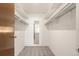 A spacious walk-in closet with shelving for plenty of storage with carpeted floors at 13606 E Bates Ave # 309, Aurora, CO 80014