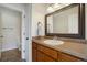 Bathroom with a single sink vanity and an adjacent toilet and shower at 749 Westward Ln, Palmer Lake, CO 80133