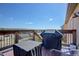 Outdoor deck area with a grill overlooking neighborhood and open space at 749 Westward Ln, Palmer Lake, CO 80133