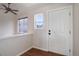 Bright foyer featuring wood floors, a large white door and a modern ceiling fan at 749 Westward Ln, Palmer Lake, CO 80133