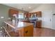 Stylish kitchen with stainless steel appliances, dark wood cabinets, and a breakfast bar at 749 Westward Ln, Palmer Lake, CO 80133