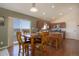 Open-concept kitchen and dining area with wood floors, stainless steel appliances, and natural light at 749 Westward Ln, Palmer Lake, CO 80133