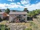 Back of house showcasing the two-story design and decks, surrounded by a natural landscape at 749 Westward Ln, Palmer Lake, CO 80133