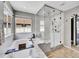 Bright bathroom with a luxurious soaking tub and a glass-enclosed shower with marble accents at 10388 Lions Path, Lone Tree, CO 80124