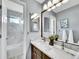 Bright bathroom with double vanity, marble countertop and walk-in shower at 10388 Lions Path, Lone Tree, CO 80124