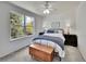 Bedroom with ceiling fan and a large window providing natural light at 10388 Lions Path, Lone Tree, CO 80124