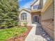 Charming home exterior featuring a combination of brick and siding, enhanced by a well-landscaped front yard at 10388 Lions Path, Lone Tree, CO 80124