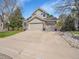 Charming two-story home with a well-manicured lawn and a spacious three car driveway at 10388 Lions Path, Lone Tree, CO 80124