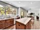 Spacious kitchen featuring custom cabinets, stainless appliances, and large windows overlooking the backyard at 10388 Lions Path, Lone Tree, CO 80124
