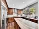 Bright kitchen featuring wood cabinets, granite countertops, stainless steel appliances, and a large window at 10388 Lions Path, Lone Tree, CO 80124