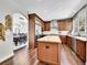 Spacious kitchen boasts wood cabinets, a large island, stainless steel appliances, and hardwood floors at 10388 Lions Path, Lone Tree, CO 80124