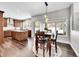Open concept kitchen with wood cabinets, stainless steel appliances, and a cozy dining area with backyard view at 10388 Lions Path, Lone Tree, CO 80124