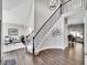 Elegant living room with high ceilings, wood floors, and a staircase with wrought iron railings at 10388 Lions Path, Lone Tree, CO 80124