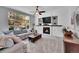 Comfortable living room with a cozy fireplace, built-in shelving, and lots of natural light at 10388 Lions Path, Lone Tree, CO 80124
