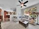 Comfortable living room features a large sectional sofa, a decorative coffee table, and a sunny window view at 10388 Lions Path, Lone Tree, CO 80124
