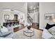 Bright living room with archway leading to the dining room and a staircase leading to the second floor at 10388 Lions Path, Lone Tree, CO 80124
