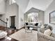 Inviting living room with a large window, high ceilings, and an elegant front door at 10388 Lions Path, Lone Tree, CO 80124