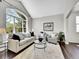 Bright living room featuring a large arched window, hardwood floors, and a neutral color palette at 10388 Lions Path, Lone Tree, CO 80124