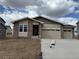 Charming single-Gathering home with a brick facade, two-car garage, and covered entry at 6975 E 126Th Dr, Thornton, CO 80602
