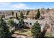 Aerial view of home with deck, mature trees, fenced yard, and mountain views at 12739 W Alabama Pl, Lakewood, CO 80228