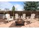 Cozy backyard patio with Adirondack chairs arranged around a modern fire pit, ideal for relaxing and socializing at 12739 W Alabama Pl, Lakewood, CO 80228